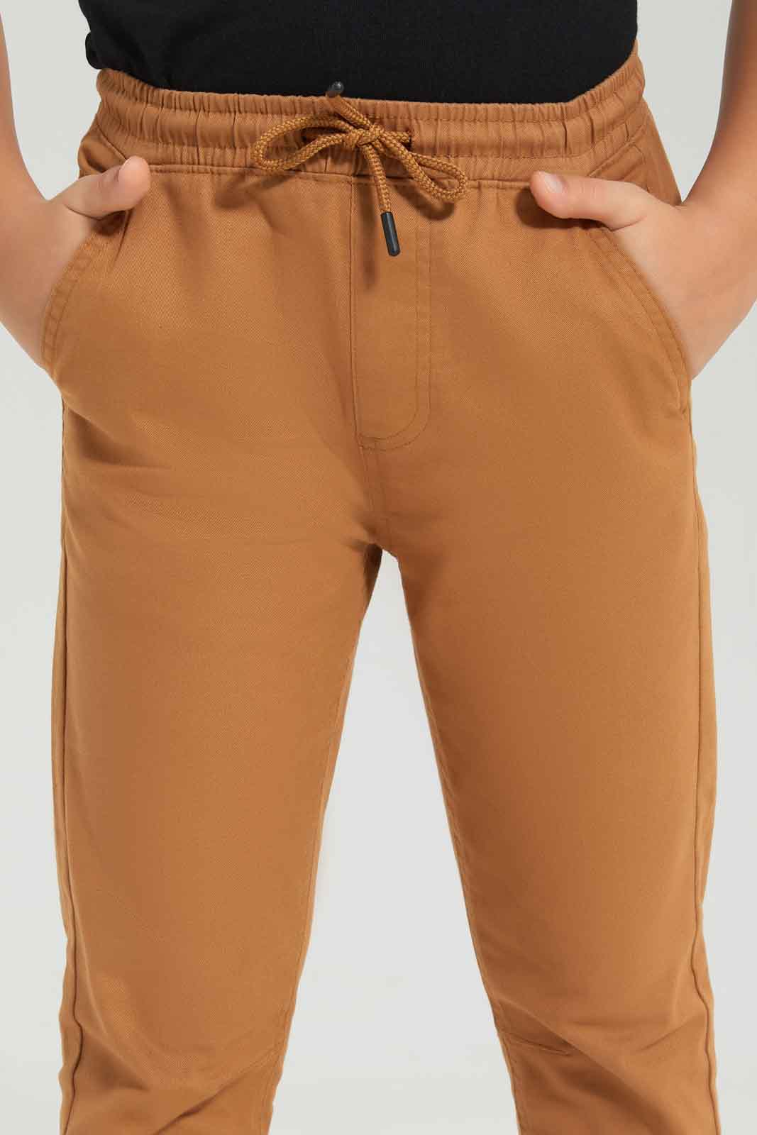 Redtag-Boys-Brown-Elasticated-Waist-Jogger-BOY-Trousers,-Category:Trousers,-Colour:Brown,-Deals:New-In,-Dept:Boys,-Filter:Boys-(2-to-8-Yrs),-New-In-BOY-APL,-Non-Sale,-S23A,-Section:Boys-(0-to-14Yrs),-VLM-Boys-2 to 8 Years