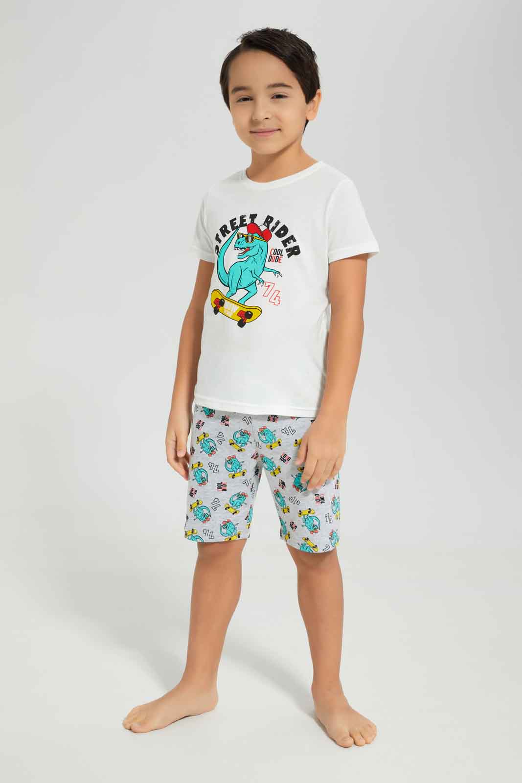 Redtag-Boys-White-Dino-Short-Sleeve-Graphic-Tee-And-Aop-Shorts-Pyjama-Set-BOY-Pyjama-Sets,-Category:Pyjama-Sets,-Colour:White,-Deals:New-In,-Dept:Boys,-Filter:Boys-(2-to-8-Yrs),-New-In-BOY-APL,-Non-Sale,-S23A,-Section:Boys-(0-to-14Yrs),-VLM-Boys-2 to 8 Years