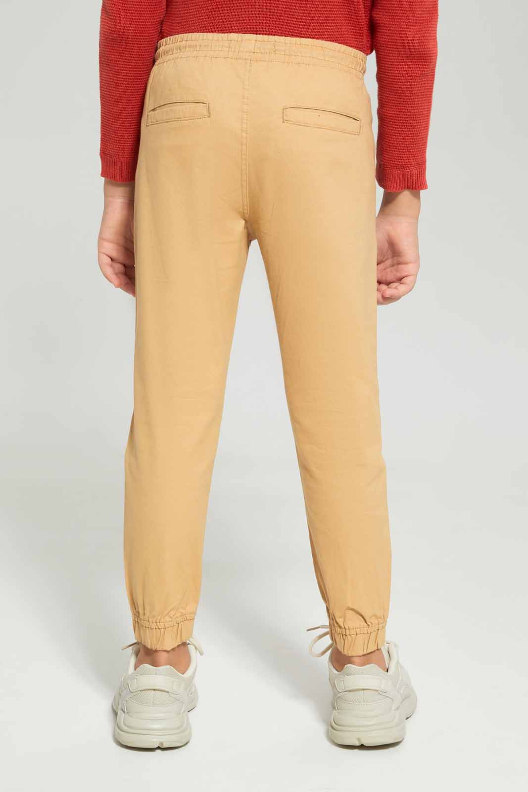 Redtag-Boys-Beige-Elasticated-Waist-Jogger-BOY-Trousers,-Category:Trousers,-Colour:Beige,-Deals:New-In,-Dept:Boys,-Filter:Boys-(2-to-8-Yrs),-New-In-BOY-APL,-Non-Sale,-S23A,-Section:Boys-(0-to-14Yrs),-VLM-Boys-2 to 8 Years