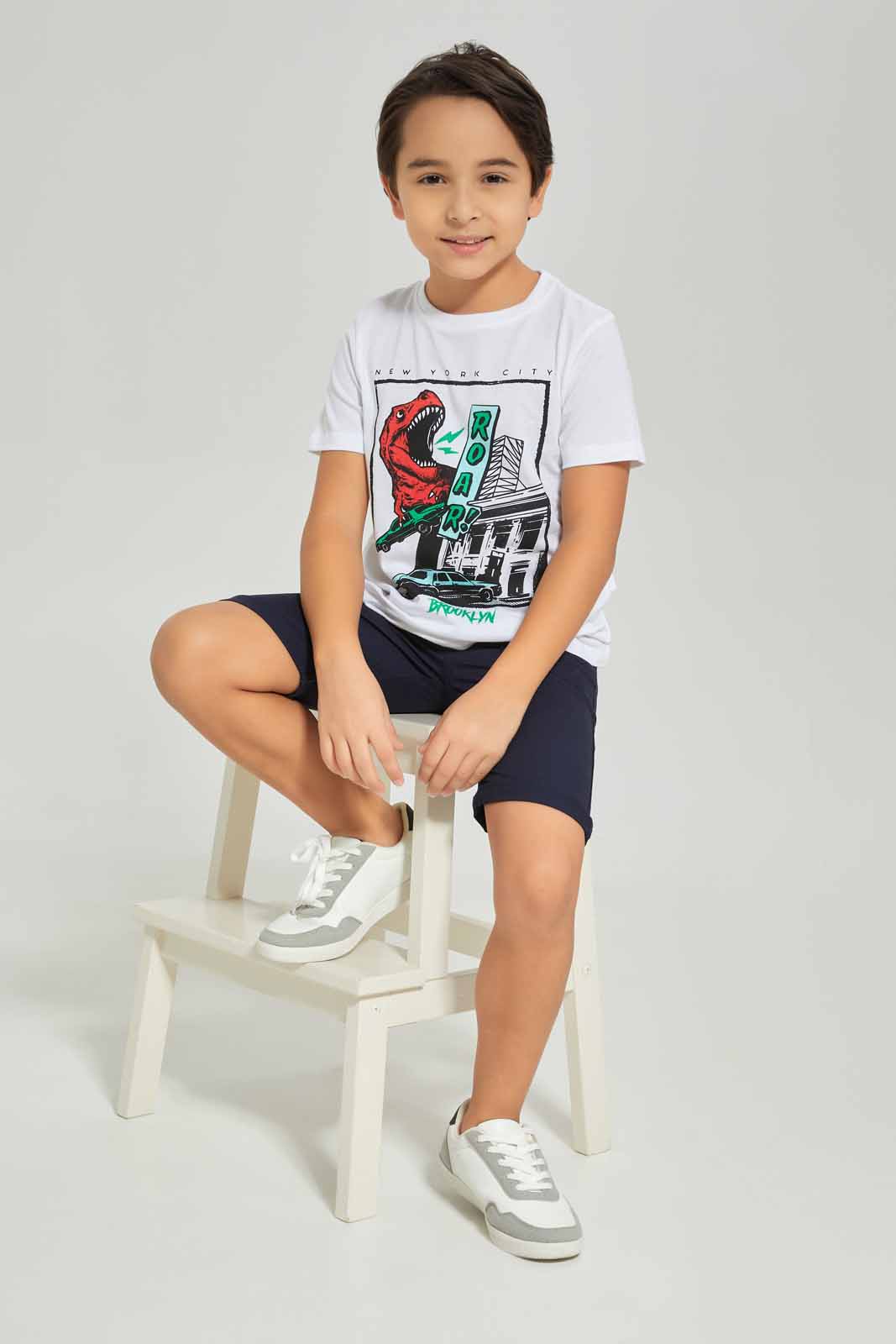 Redtag-Boys-White-Dino-Short-Sleeve-Graphic-T-Shirt-BOY-T-Shirts,-Category:T-Shirts,-Colour:White,-Deals:New-In,-Dept:Boys,-Filter:Boys-(2-to-8-Yrs),-New-In-BOY-APL,-Non-Sale,-S23A,-Section:Boys-(0-to-14Yrs),-TBL-Boys-2 to 8 Years