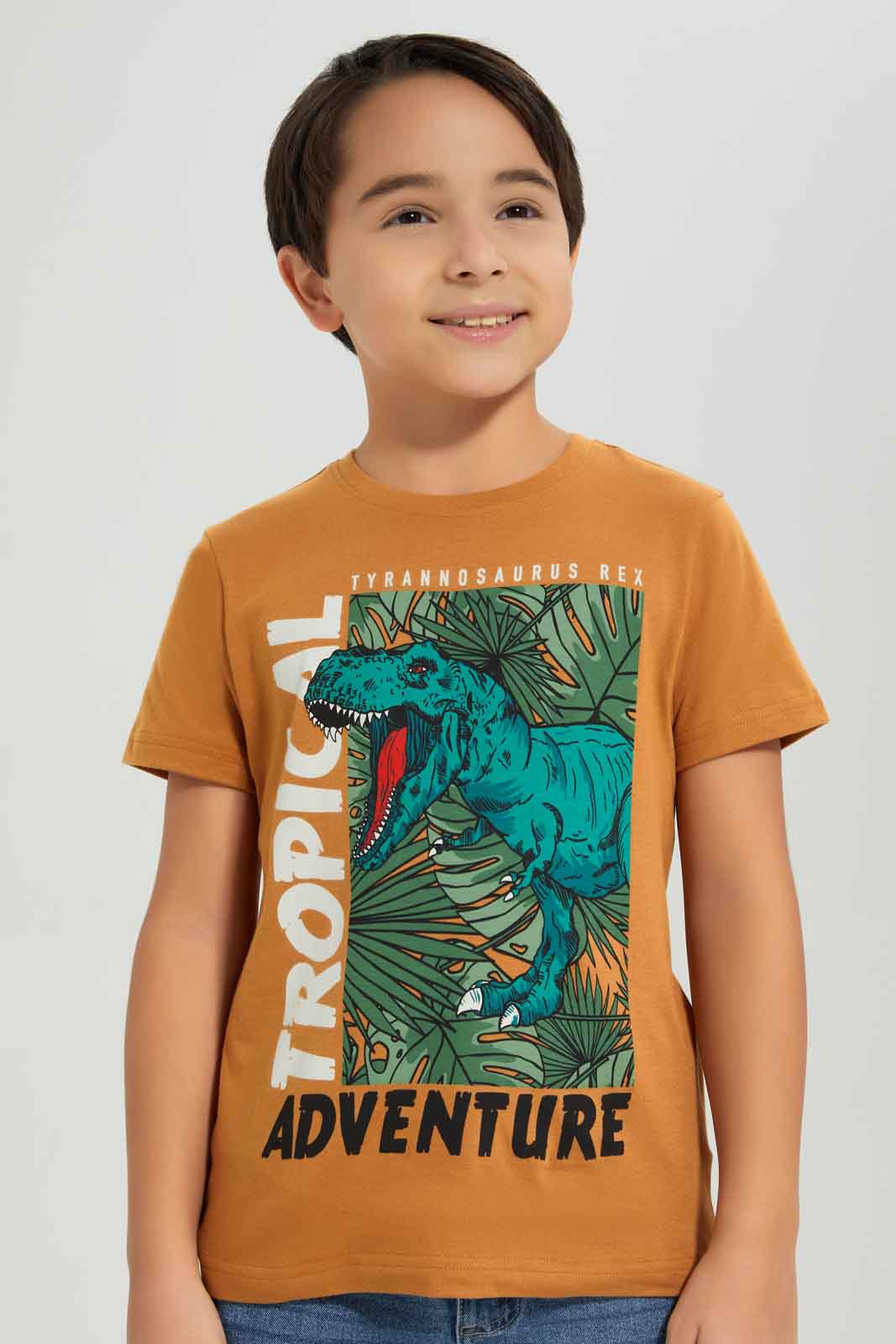 Redtag-Boys-Brown-Dino-Short-Sleeve-Graphic-T-Shirt-BOY-T-Shirts,-Category:T-Shirts,-Colour:Brown,-Deals:New-In,-Dept:Boys,-Filter:Boys-(2-to-8-Yrs),-New-In-BOY-APL,-Non-Sale,-S23A,-Section:Boys-(0-to-14Yrs),-TBL-Boys-2 to 8 Years